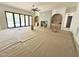 Large living room with a fireplace, built-in shelves, and folding doors at 7208 Tanbark Way, Raleigh, NC 27615