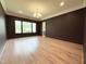 A large living room featuring a dark accent wall and big bright window at 7208 Tanbark Way, Raleigh, NC 27615