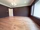 A large living room featuring a dark accent wall, white trim, and big bright window at 7208 Tanbark Way, Raleigh, NC 27615