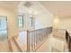 Open loft area with hardwood floors, iron railing, and modern light fixtures at 7208 Tanbark Way, Raleigh, NC 27615