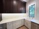 Spacious butler's pantry with custom cabinets, white countertops, undermount lighting, and stainless steel appliances at 7208 Tanbark Way, Raleigh, NC 27615
