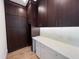 Custom butler's pantry with built-in dark cabinets, white countertop space, undermount lighting, and hardwood floors at 7208 Tanbark Way, Raleigh, NC 27615