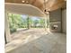 Covered outdoor patio with a brick fireplace and lush green views at 7208 Tanbark Way, Raleigh, NC 27615