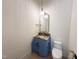 Modern powder room featuring stone countertop, designer mirror, and stylish pendant lighting at 7208 Tanbark Way, Raleigh, NC 27615