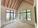 Bright room featuring wood ceiling, large black-framed windows and natural light at 7208 Tanbark Way, Raleigh, NC 27615