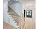 Beautiful staircase with contemporary iron railings and light wood steps leading to the upper level at 7208 Tanbark Way, Raleigh, NC 27615