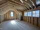 Unfinished attic space showing framing, windows, and natural light at 7208 Tanbark Way, Raleigh, NC 27615