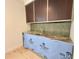 Detailed wet bar area with custom cabinetry, granite countertops, and a unique tile backsplash at 7208 Tanbark Way, Raleigh, NC 27615