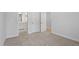 This bedroom features neutral carpeting, white trim, and doorways to other areas at 100 Bold Dr, Youngsville, NC 27596
