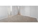 This bedroom features neutral carpeting, white trim, and doorways to other areas at 100 Bold Dr, Youngsville, NC 27596