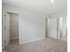 This bedroom features neutral carpeting, white trim, and a walk in closet at 100 Bold Dr, Youngsville, NC 27596