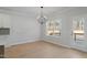 Bright dining area with hardwood floors, a chandelier, and natural light from the windows at 100 Bold Dr, Youngsville, NC 27596