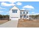 Beautiful two-story home featuring an attached two-car garage, well-kept lawn and landscaped front yard at 100 Bold Dr, Youngsville, NC 27596