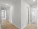 Bright hallway with hardwood floors and white walls at 100 Bold Dr, Youngsville, NC 27596