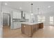 Open kitchen with a large center island, stainless steel appliances, and plenty of cabinet space at 100 Bold Dr, Youngsville, NC 27596