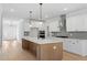 Modern kitchen featuring white cabinets, stainless steel appliances, and center island at 100 Bold Dr, Youngsville, NC 27596