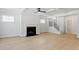 Spacious living room featuring a fireplace, large windows, and hardwood floors at 100 Bold Dr, Youngsville, NC 27596