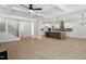 Open floor plan with island kitchen, light wood floors, and staircase at 100 Bold Dr, Youngsville, NC 27596