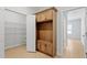 This mudroom features a wooden storage unit with hooks, a seat, and cabinets at 100 Bold Dr, Youngsville, NC 27596