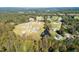 Stunning aerial view of a community featuring lush landscaping and homes with sparkling swimming pools at 126 Harvest Ln, Pittsboro, NC 27312