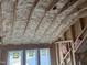 Exposed attic with foam insulation showing the structure of the ceiling and roof at 126 Harvest Ln, Pittsboro, NC 27312
