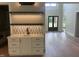 Entertainment area with a stylish marble countertop, black faucet, and built-in cabinets and drawers at 126 Harvest Ln, Pittsboro, NC 27312