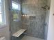 Bathroom glass-enclosed shower stall with rain shower head, built-in bench, and a window at 126 Harvest Ln, Pittsboro, NC 27312