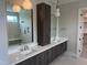 Elegant bathroom with double vanity, wood cabinetry, quartz counters, and modern mirrors at 126 Harvest Ln, Pittsboro, NC 27312