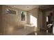 Bright bathroom features stone flooring, a modern bathtub, and lots of sunlight at 126 Harvest Ln, Pittsboro, NC 27312