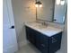 Bathroom features a modern vanity with dark wood cabinets, marble countertop, and a large mirror at 126 Harvest Ln, Pittsboro, NC 27312