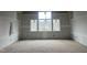 Bright bedroom featuring high ceilings and large windows offering neighborhood views; under construction at 126 Harvest Ln, Pittsboro, NC 27312