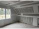 Attic bedroom featuring high ceilings and natural light from a large window; under construction at 126 Harvest Ln, Pittsboro, NC 27312