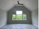 Spacious bedroom with vaulted ceilings and a large window offering scenic views at 126 Harvest Ln, Pittsboro, NC 27312