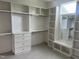 Bright walk-in closet features custom shelving, drawers, hanging rods, and a built-in bench with mirror at 126 Harvest Ln, Pittsboro, NC 27312