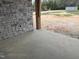 View of a stone wall and gray stamped concrete patio, offering a durable and attractive outdoor living space at 126 Harvest Ln, Pittsboro, NC 27312