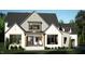 Rendering of a modern farmhouse with gray and white stone exterior, and covered front porch at 126 Harvest Ln, Pittsboro, NC 27312