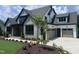 Beautiful new construction home featuring stone accents and a three-car garage at 126 Harvest Ln, Pittsboro, NC 27312