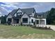 Stunning new two story home with stone accents, black trim windows, and manicured lawn at 126 Harvest Ln, Pittsboro, NC 27312