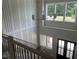 Grand foyer with soaring ceilings, stylish lighting, a modern staircase, and a black front door at 126 Harvest Ln, Pittsboro, NC 27312
