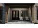 Inviting front porch with stone accents, a dark brown door, and comfortable seating at 126 Harvest Ln, Pittsboro, NC 27312