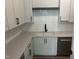 Clean kitchenette with white cabinets, dark hardware, and an undermount sink, tiled backsplash at 126 Harvest Ln, Pittsboro, NC 27312