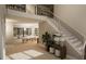 Open-concept living room with hardwood floors, modern staircase, and comfortable seating arrangement at 126 Harvest Ln, Pittsboro, NC 27312