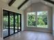 Sun-filled living room boasting hardwood floors, vaulted ceilings, and beautiful backyard views at 126 Harvest Ln, Pittsboro, NC 27312