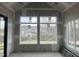 Unfinished living room with two large windows with outdoor view. New construction at 126 Harvest Ln, Pittsboro, NC 27312
