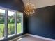 Living room with large window offering outside views and modern light fixture at 126 Harvest Ln, Pittsboro, NC 27312