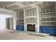 Living room under construction showcasing a fireplace with built-in shelving at 126 Harvest Ln, Pittsboro, NC 27312