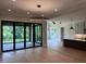 Open concept living area leading to a kitchen with island and sliding doors to outdoor deck at 126 Harvest Ln, Pittsboro, NC 27312