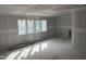A large living room under construction with three windows and light coming in at 126 Harvest Ln, Pittsboro, NC 27312
