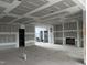 Spacious living room featuring modern fireplace, recessed lighting, and open floor plan; under construction at 126 Harvest Ln, Pittsboro, NC 27312