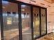 Image of a large black frame patio door with an unfinished interior view at 126 Harvest Ln, Pittsboro, NC 27312